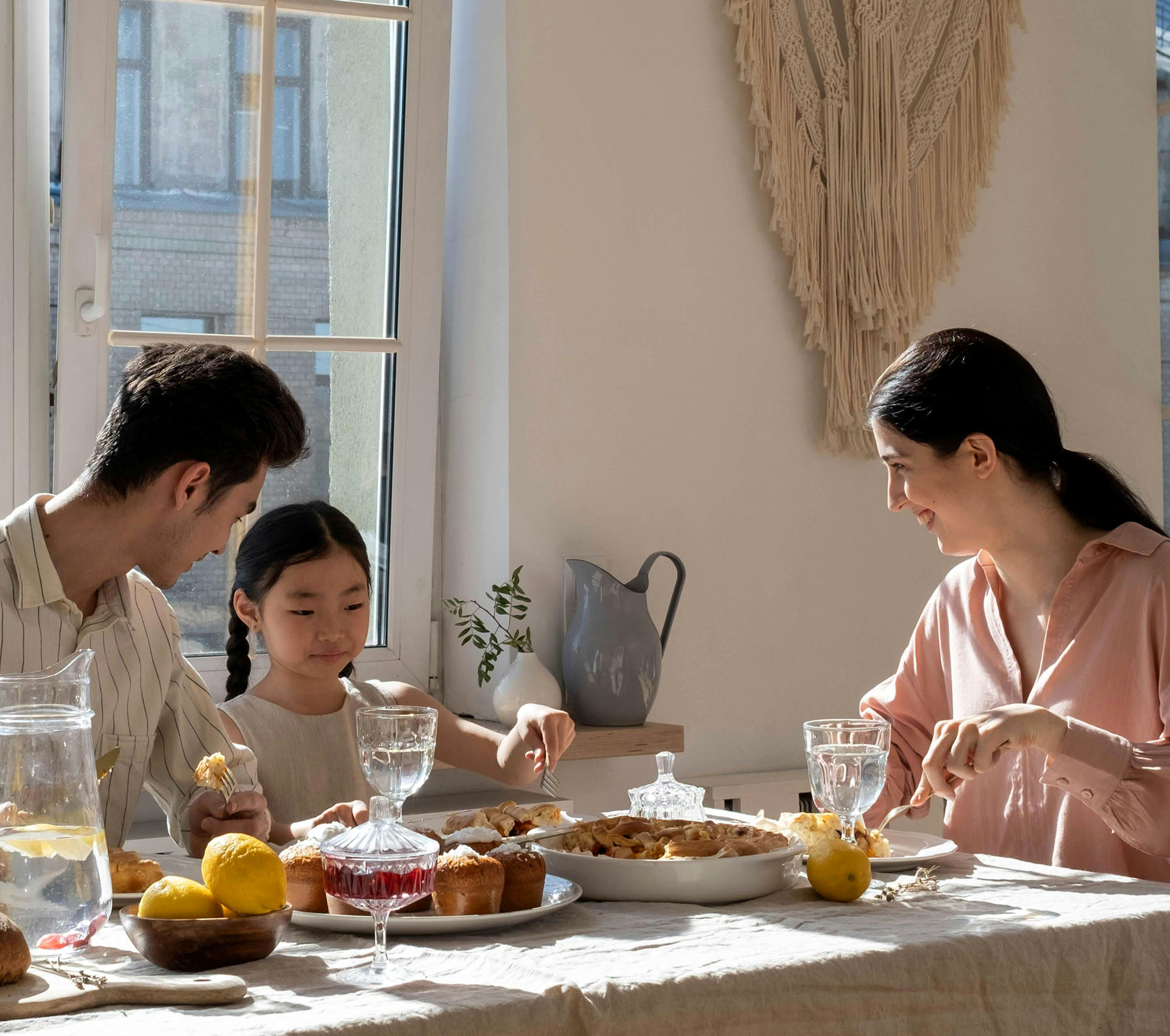 Happy family of 3 having a meal - Banner