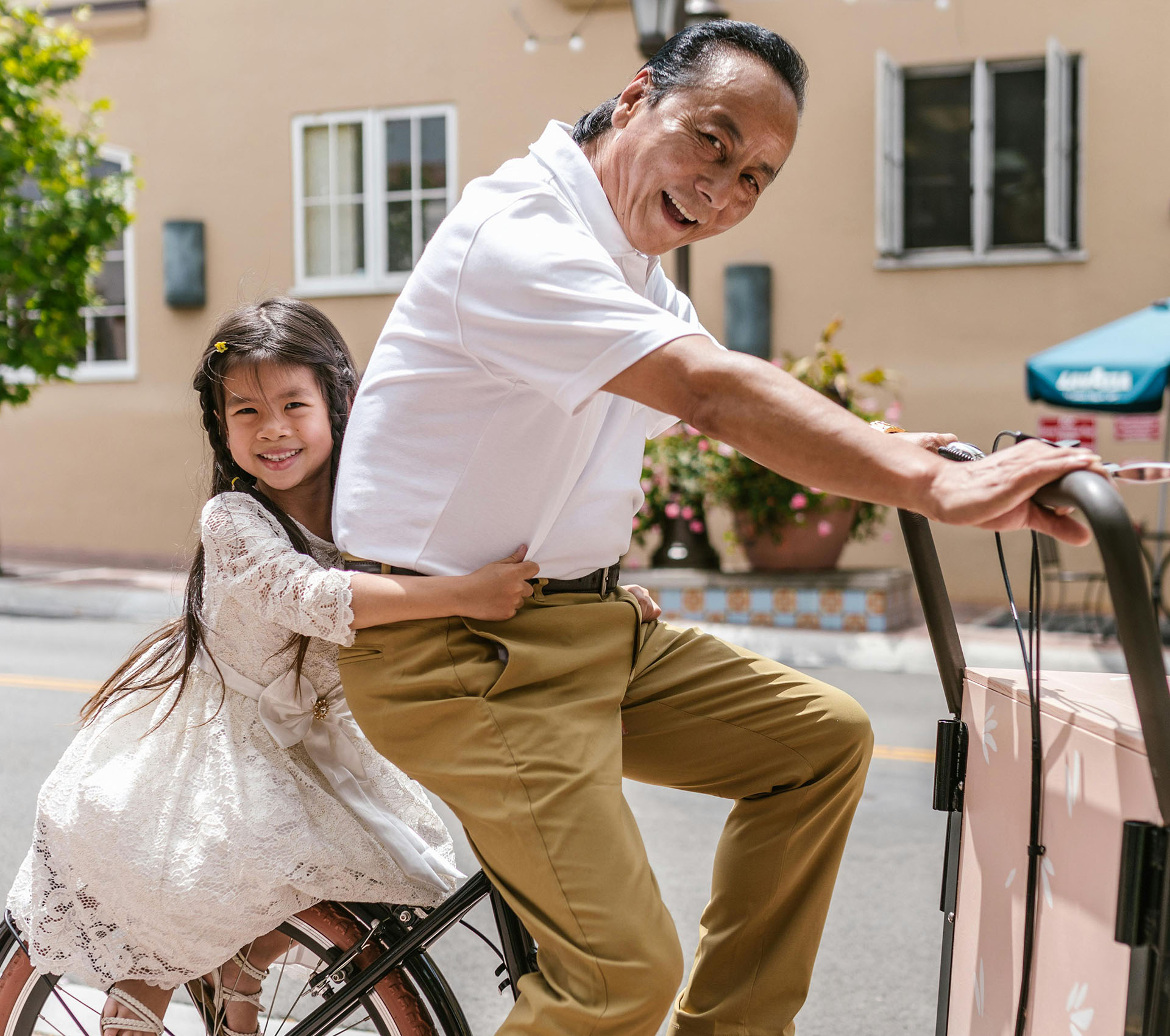 Happy grandfather with granddaughter on bike - Banner