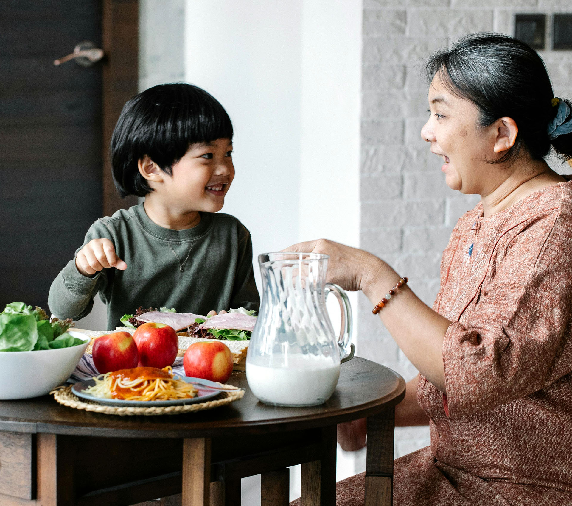 Happy grandmother with grandson having a meal - Banner